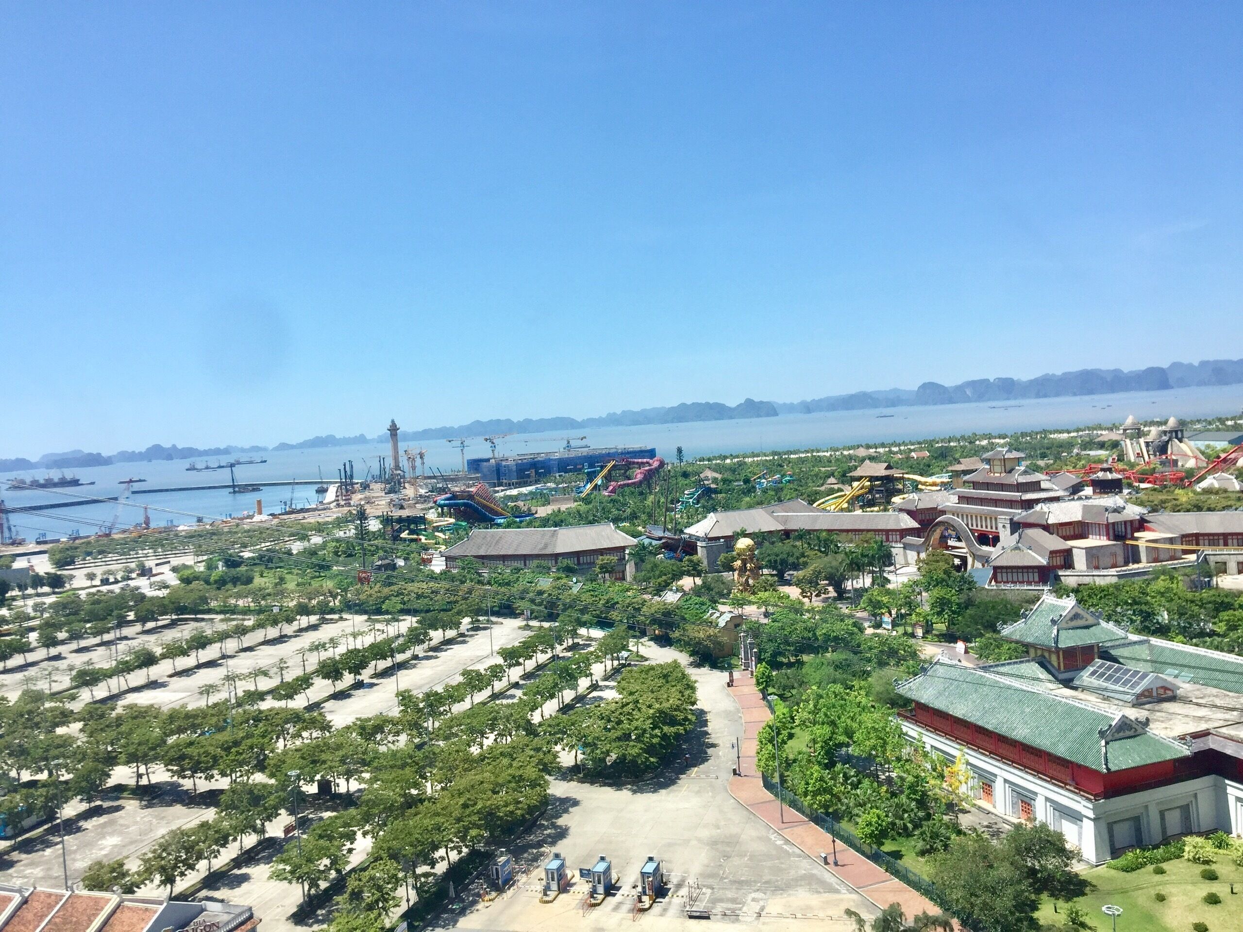 A coastal resort with a large parking area, water park, and traditional architecture.
