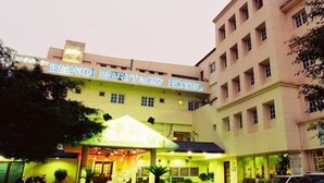 A hotel with a sign reading "HANOI HERITAGE HOTEL".