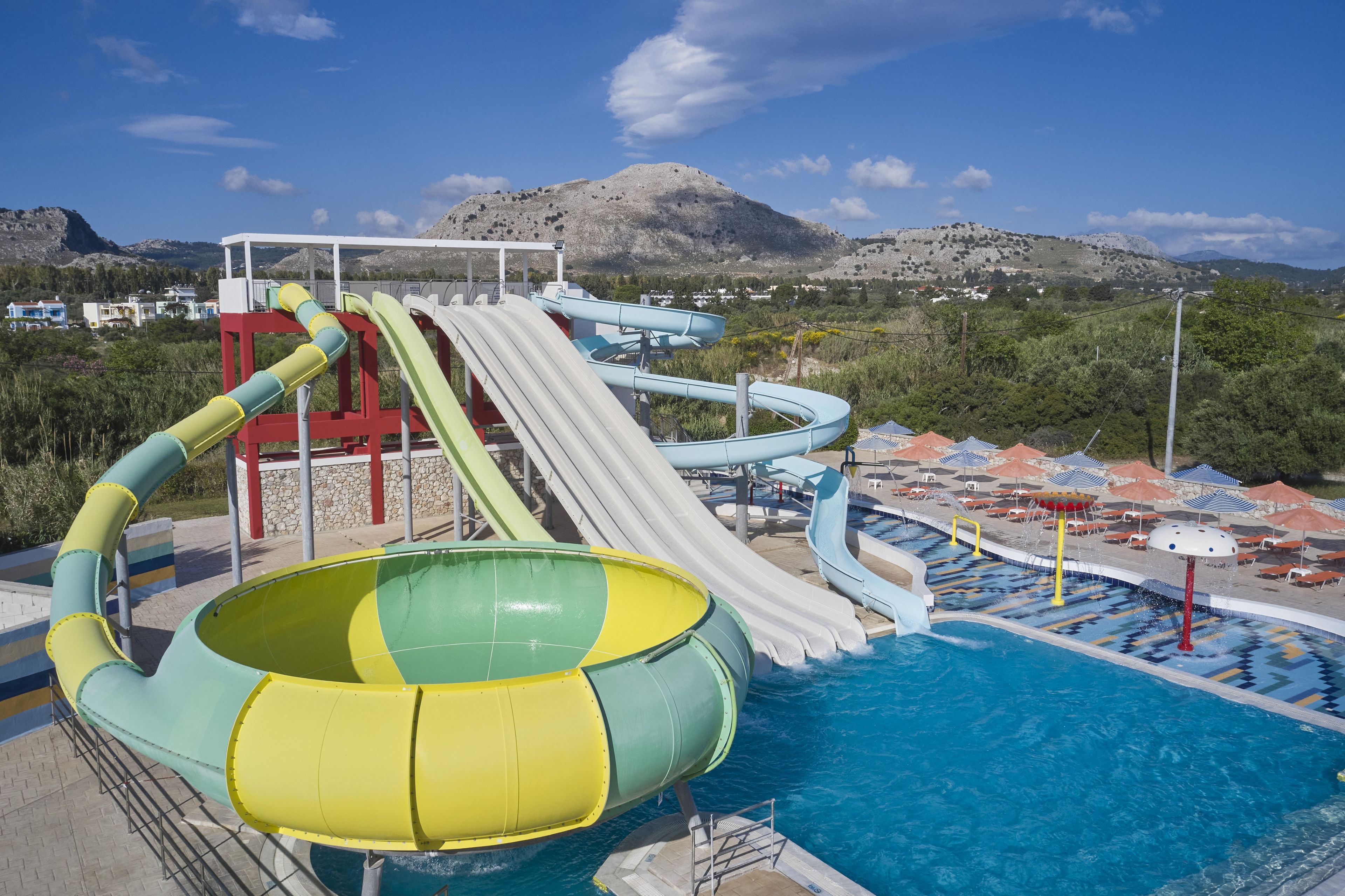 A water park with multiple slides and a pool area.