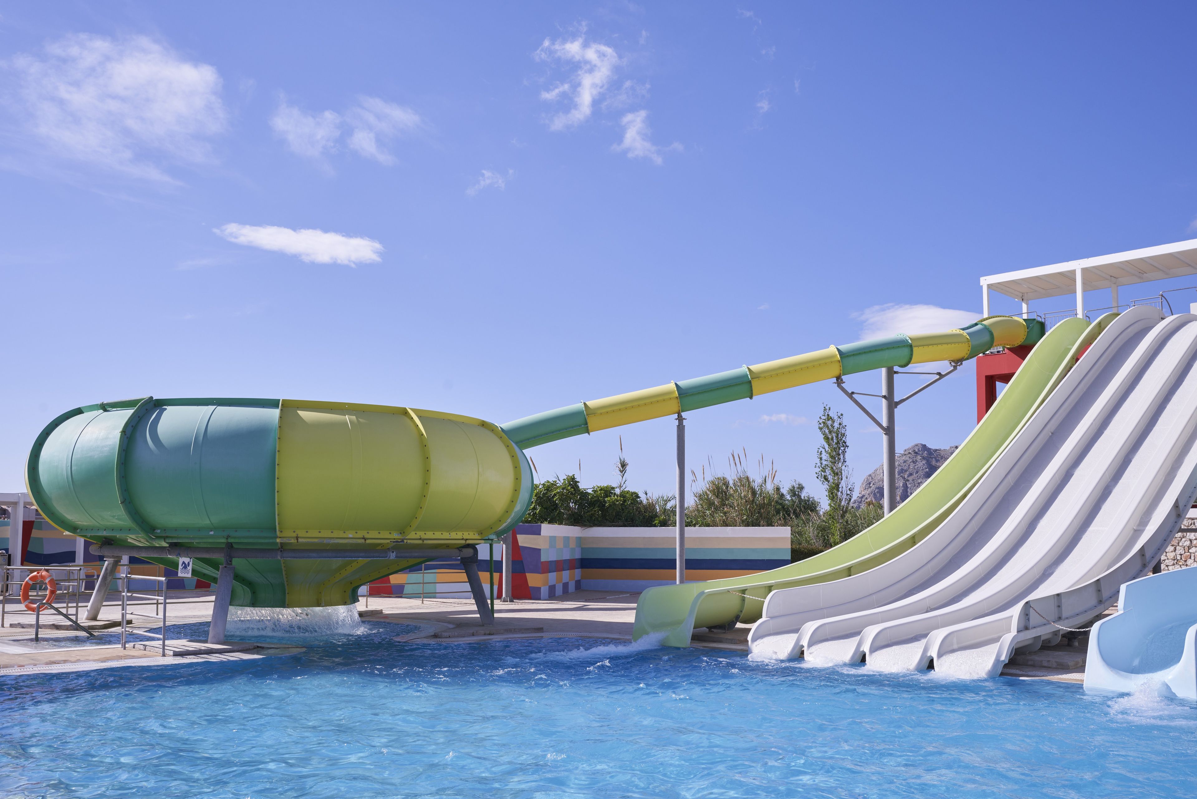A water park with a large water slide and a pool.