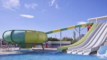 A water park with a large water slide and a pool.
