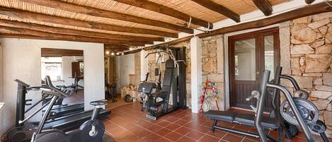 A gym with treadmills, a stationary bike, and weight machines.