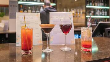 A bar area with three different drinks on the counter.