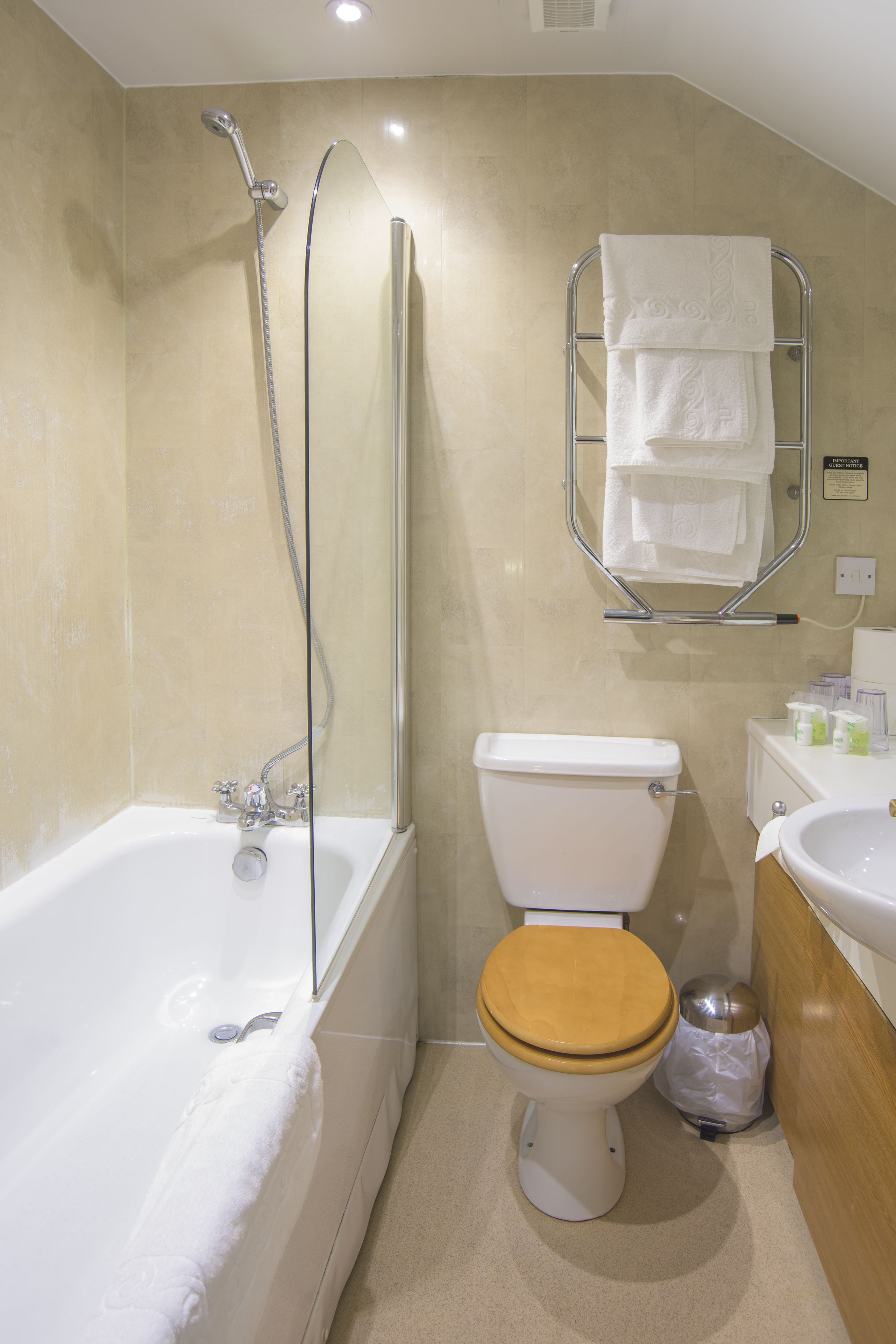 A bathroom with a bathtub, toilet, and sink.