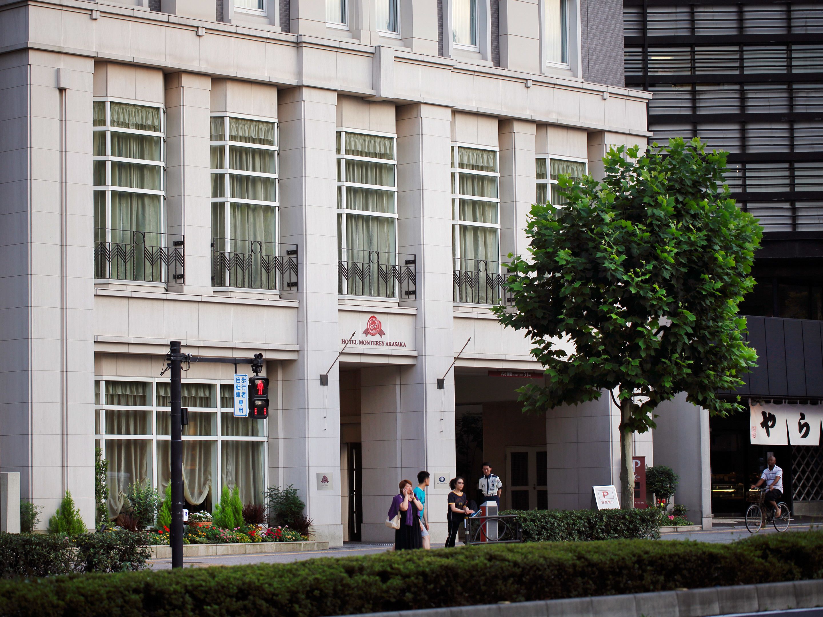A hotel with a modern facade, multiple windows, and a visible entrance.