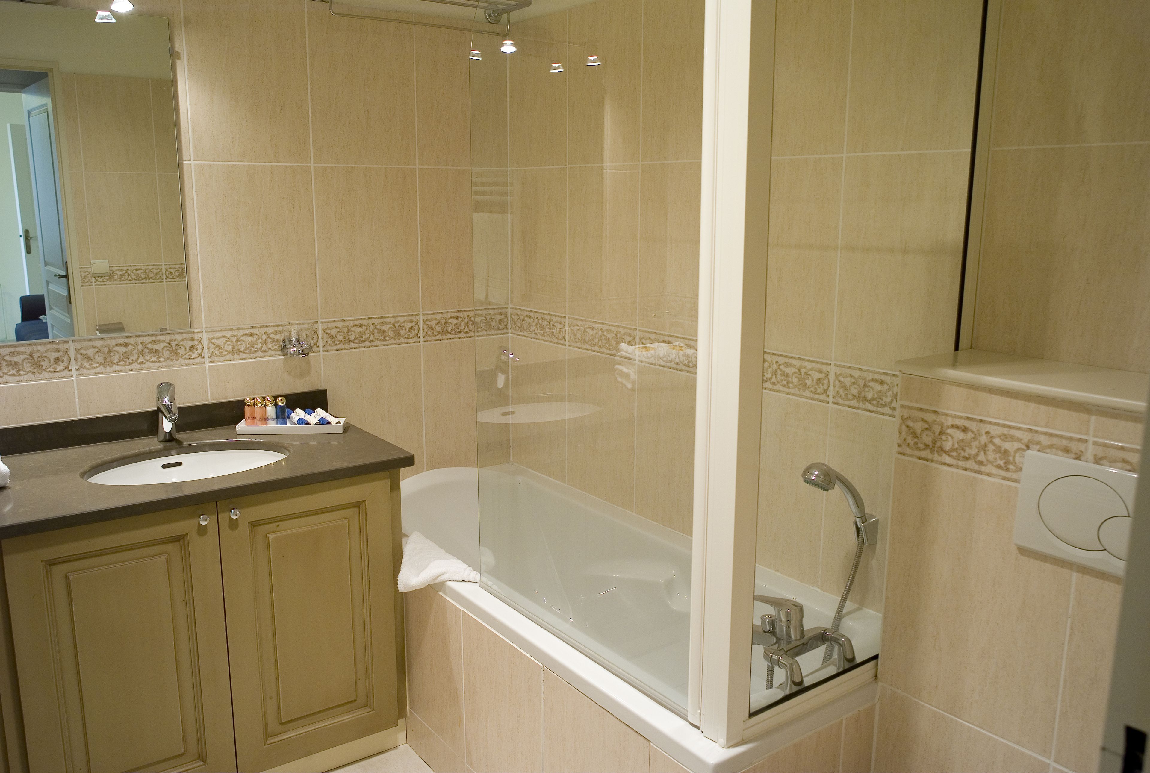 A bathroom with a bathtub, a shower, and a sink.