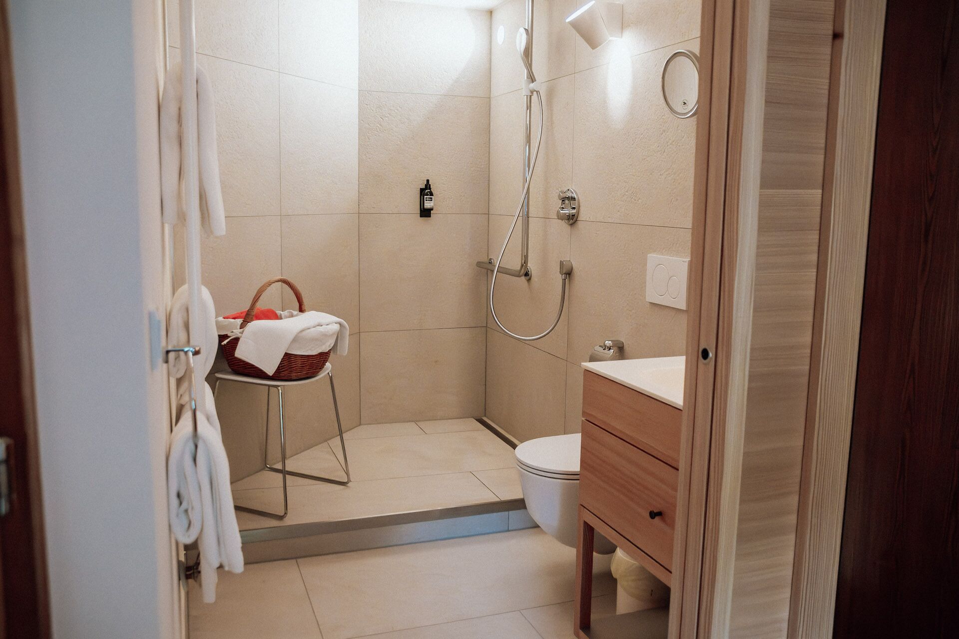 A modern bathroom with a shower, toilet, and vanity.