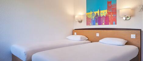 A hotel room with two beds, a wooden headboard, and a colorful cityscape painting on the wall.