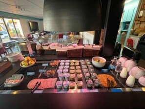 A breakfast buffet with various food items and a coffee station. - Kyriad Direct Soissons (Soissons)