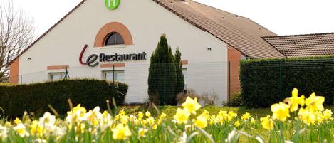A building with a sign that reads "eRestaurant" and a green logo above it.