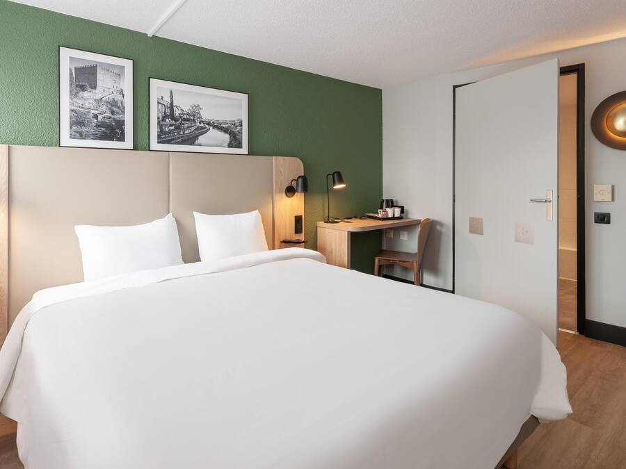 Premium bedding, desk, laptop workspace, blackout curtains