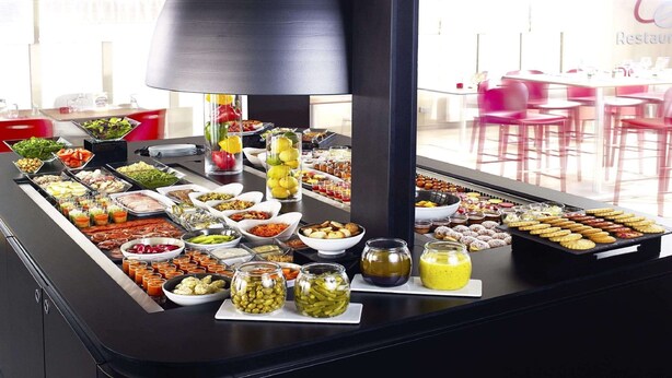 A buffet with various food items and condiments. - The Originals City, Hôtel La Verrière – Yvelines (La Verriere)