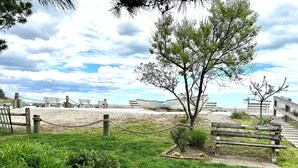 A coastal park with a wooden walkway, benches, and a shipwreck. - Esplanade Suites, a Sundance Vacations Property (Wildwood)