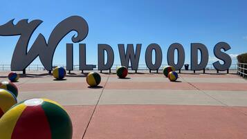 A beach area with large 'WILDWOOODS' letters and colorful beach balls.