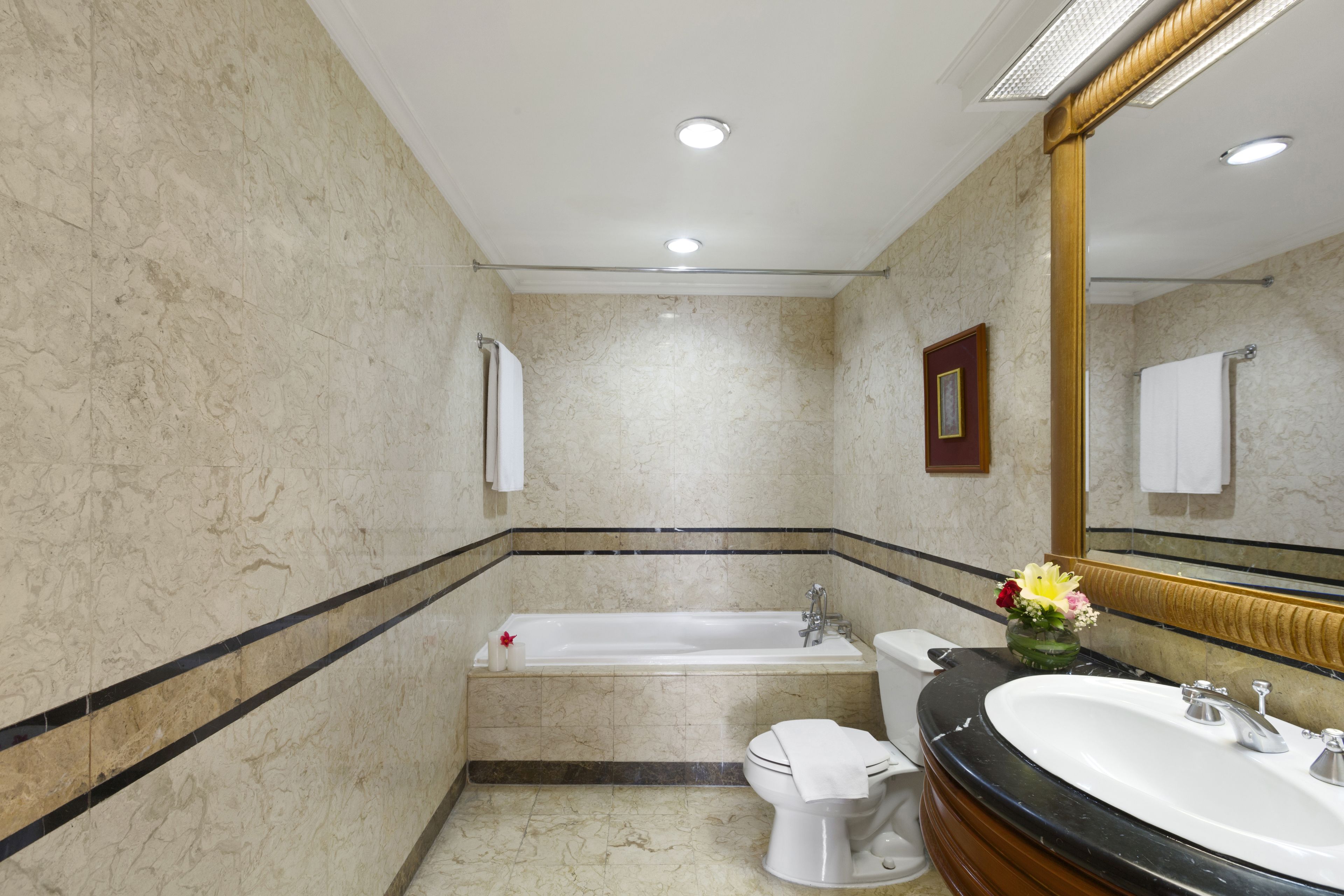 A bathroom with a bathtub, toilet, and sink.