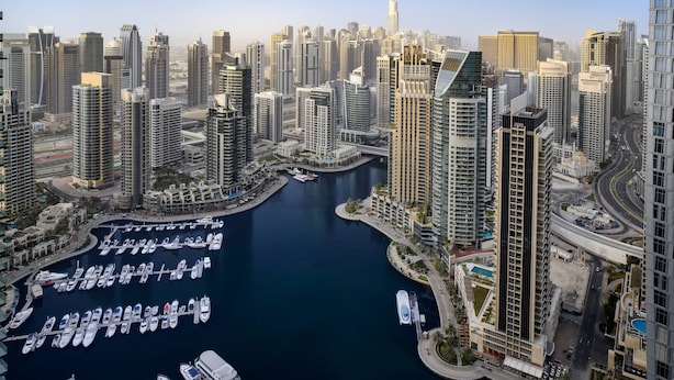A high-rise urban area with a marina filled with boats.