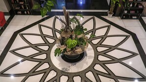 A potted plant arrangement on a geometric patterned floor. - Somerset Millennium Makati (Makati)