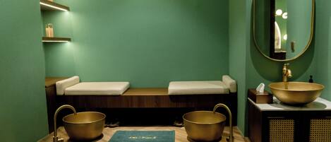 A bathroom with a wooden vanity, two sinks, a large mirror, and a towel rack.