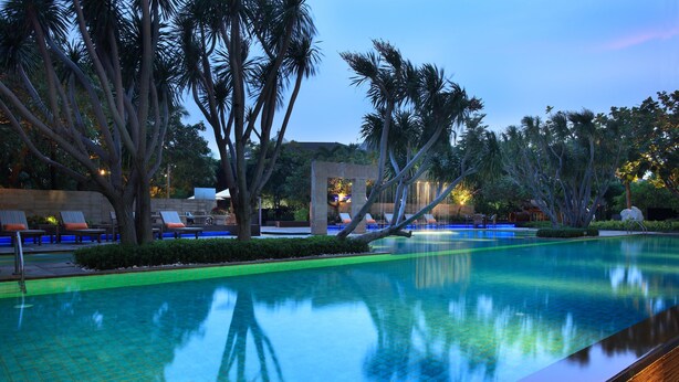A serene pool area with lounge chairs and palm trees. - Somerset Berlian Jakarta (Jakarta)
