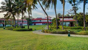 Stroll through the beautifully manicured grounds, surrounded by lush tropical plants and palm trees, to the entrance of this modern hotel.