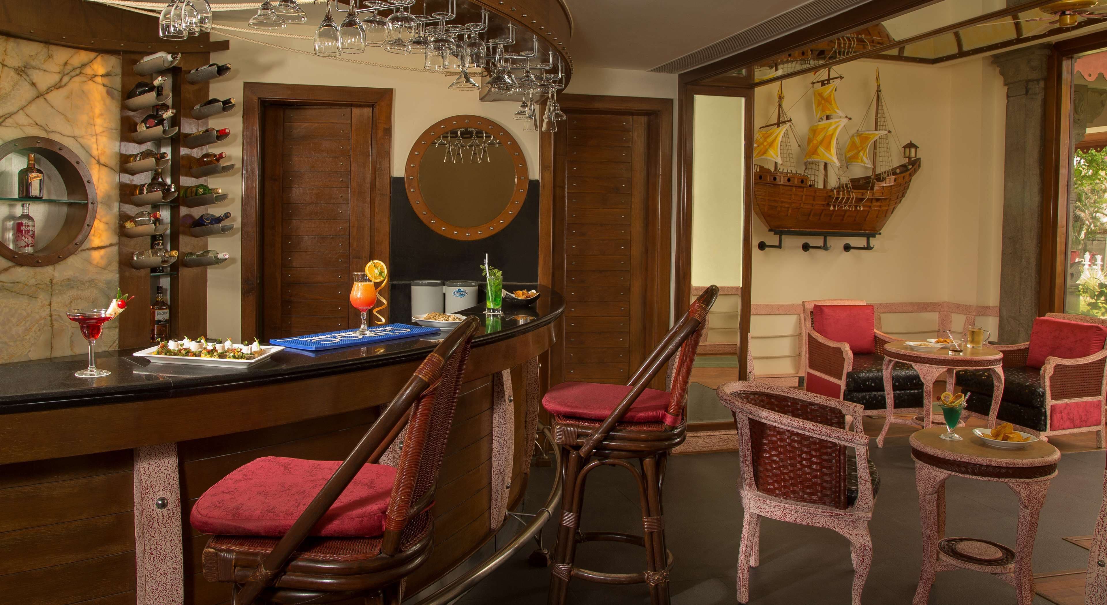 A bar area with a wine rack, a mirror, and a ship decoration on the wall.