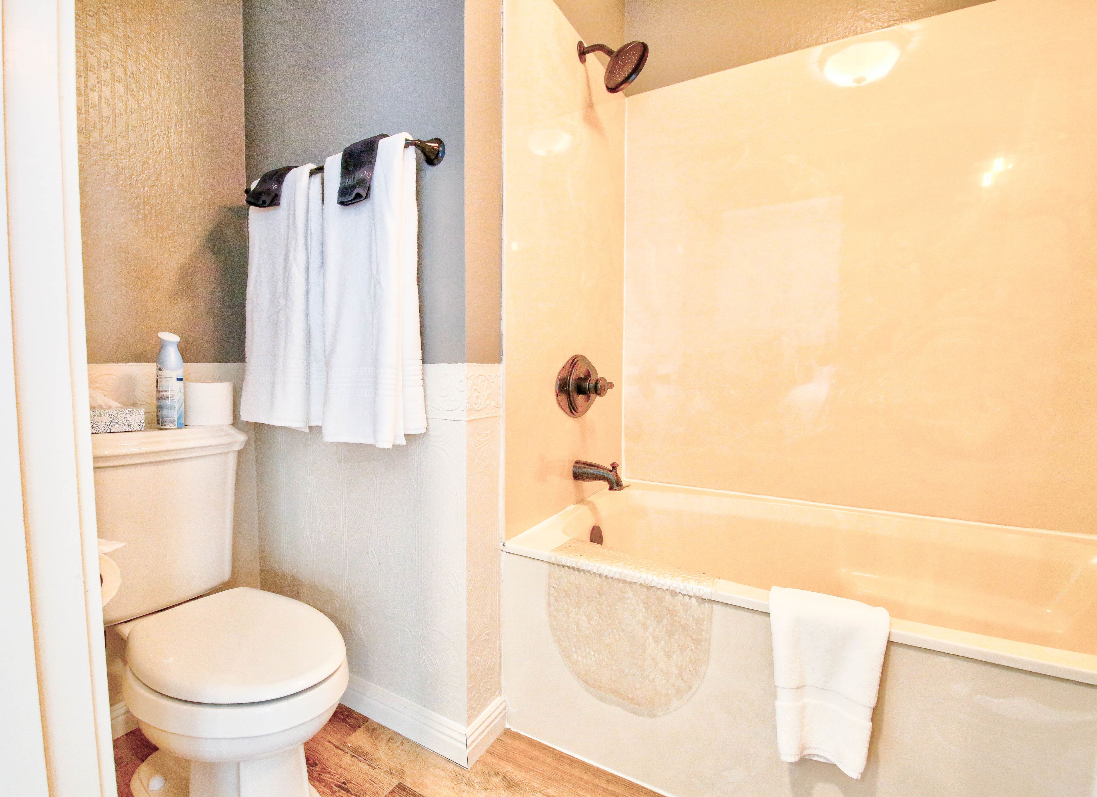 A bathroom with a toilet, a sink, a shower, and a bathtub.
