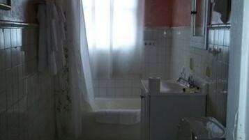 A small bathroom with a toilet, sink, and bathtub.