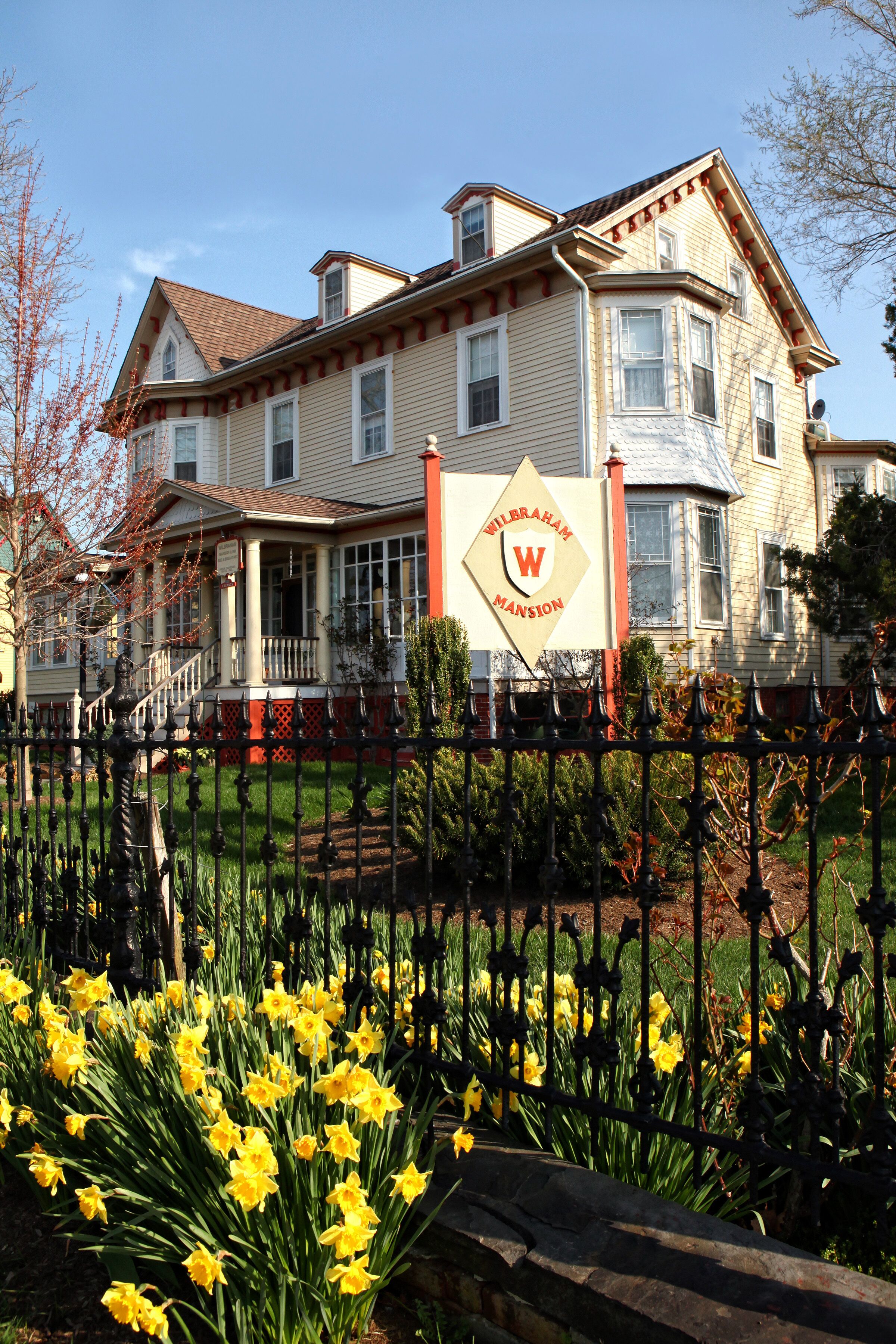 A historic building with a prominent sign reading "WILERHAM MANSION."