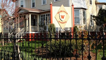 A historic building with a prominent sign reading "WILERHAM MANSION."