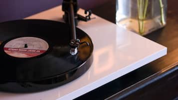 A vinyl record on a white turntable with a label reading "Record Store Day UK."