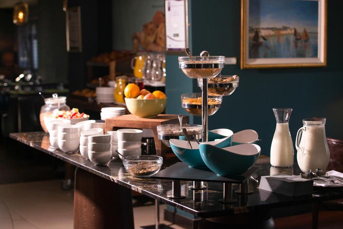 A breakfast buffet with various food items and beverages.