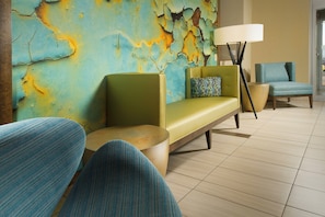 A modern lounge area with a sofa, armchairs, and a lamp. - Holiday Inn El Paso Airport by IHG (El Paso)
