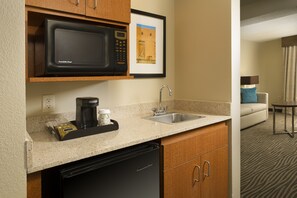 A kitchen with a microwave, coffee maker, and dishwasher. - Holiday Inn El Paso Airport by IHG (El Paso)