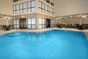 A swimming pool with a 3 FT and 4 FT depth marking, surrounded by lounge chairs and umbrellas. - Holiday Inn El Paso Airport by IHG (El Paso)