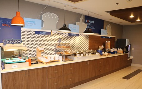 A breakfast area with a bakery, hot food, and express breakfast options.