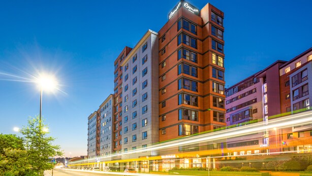 A multi-story hotel with a modern design, featuring a prominent sign at the top. - Roomzzz Leeds City West (Leeds)