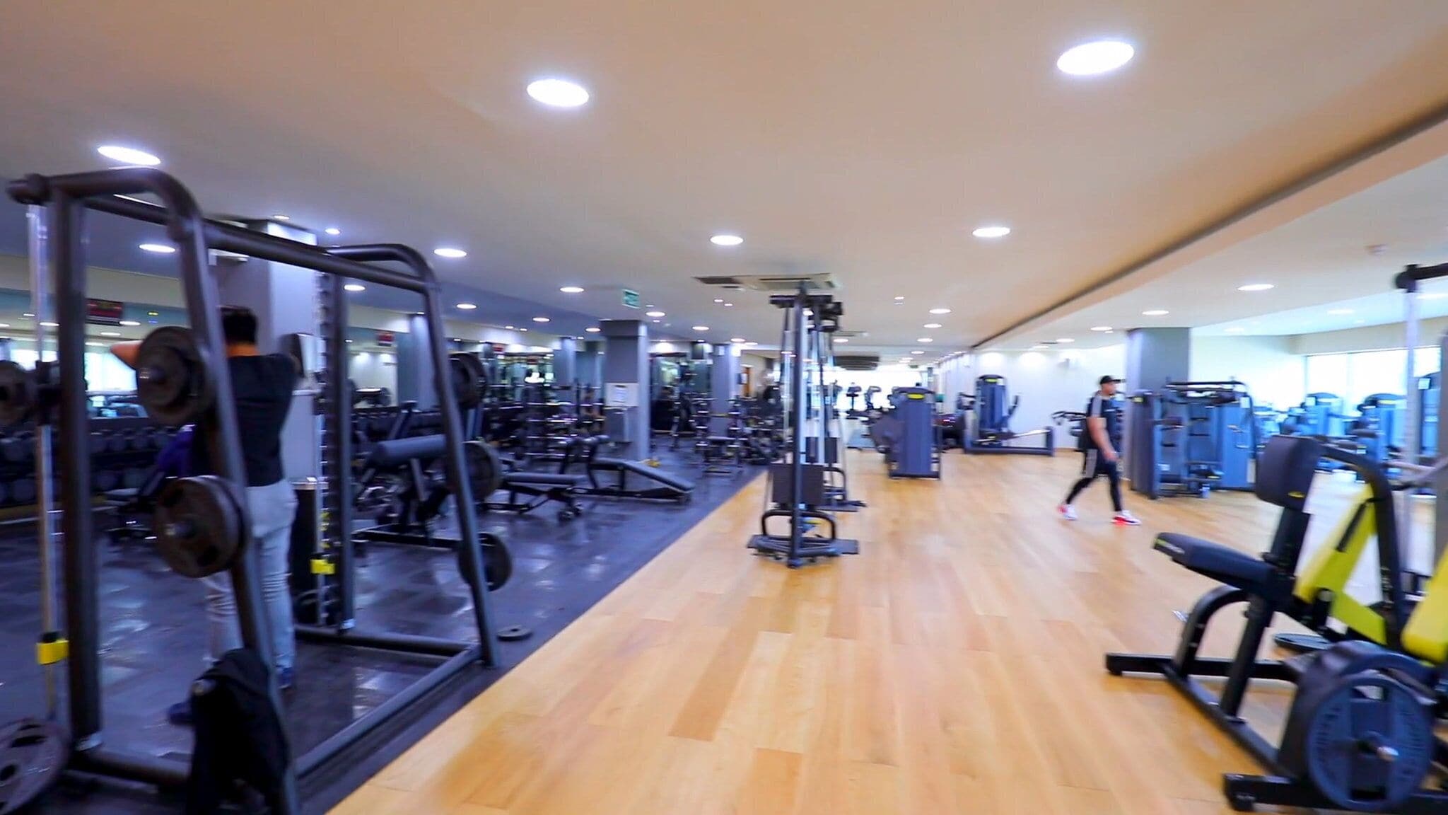 A gym with various exercise equipment, including weight machines and treadmills.