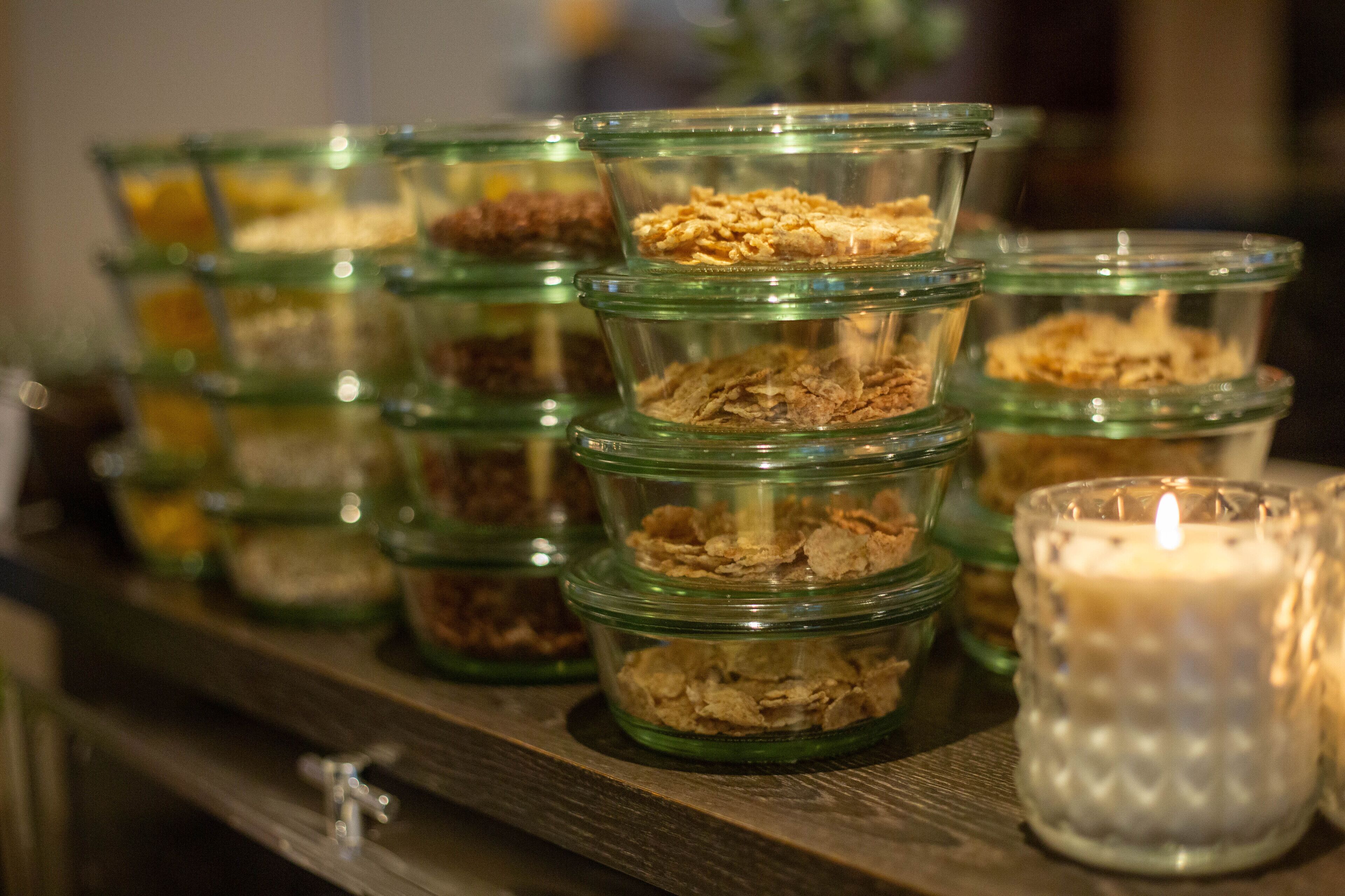 Glass jars with different food items on a shelf.