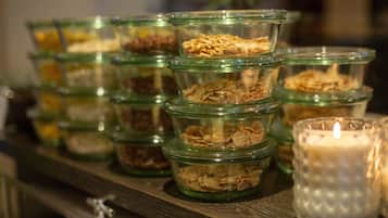 Glass jars with different food items on a shelf.