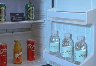 A refrigerator with beverages including cans and bottles.