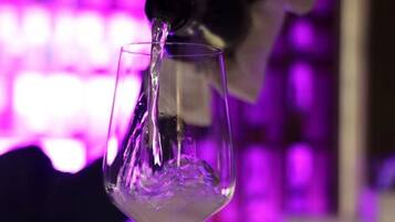 A clear glass of water being poured into a stemmed glass.