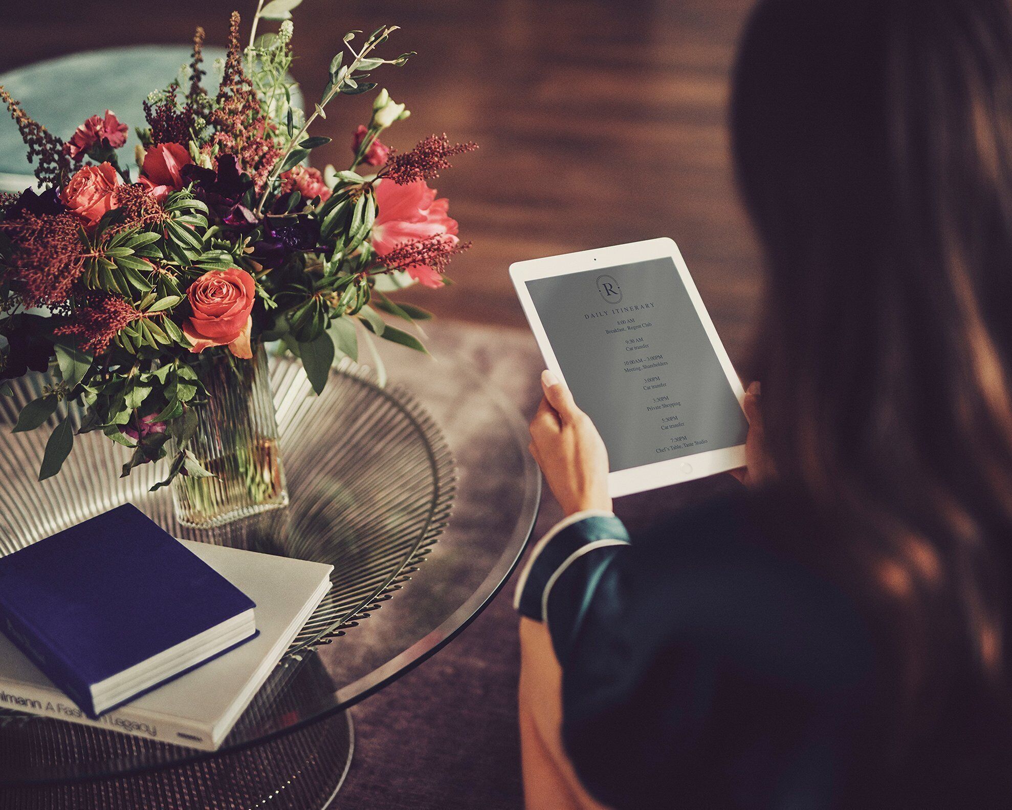 A person holding a tablet with a daily itinerary.