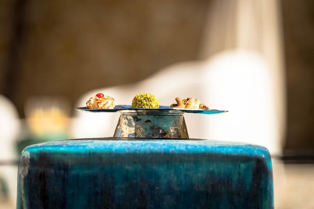 A blue table with a glass top displaying various food items.