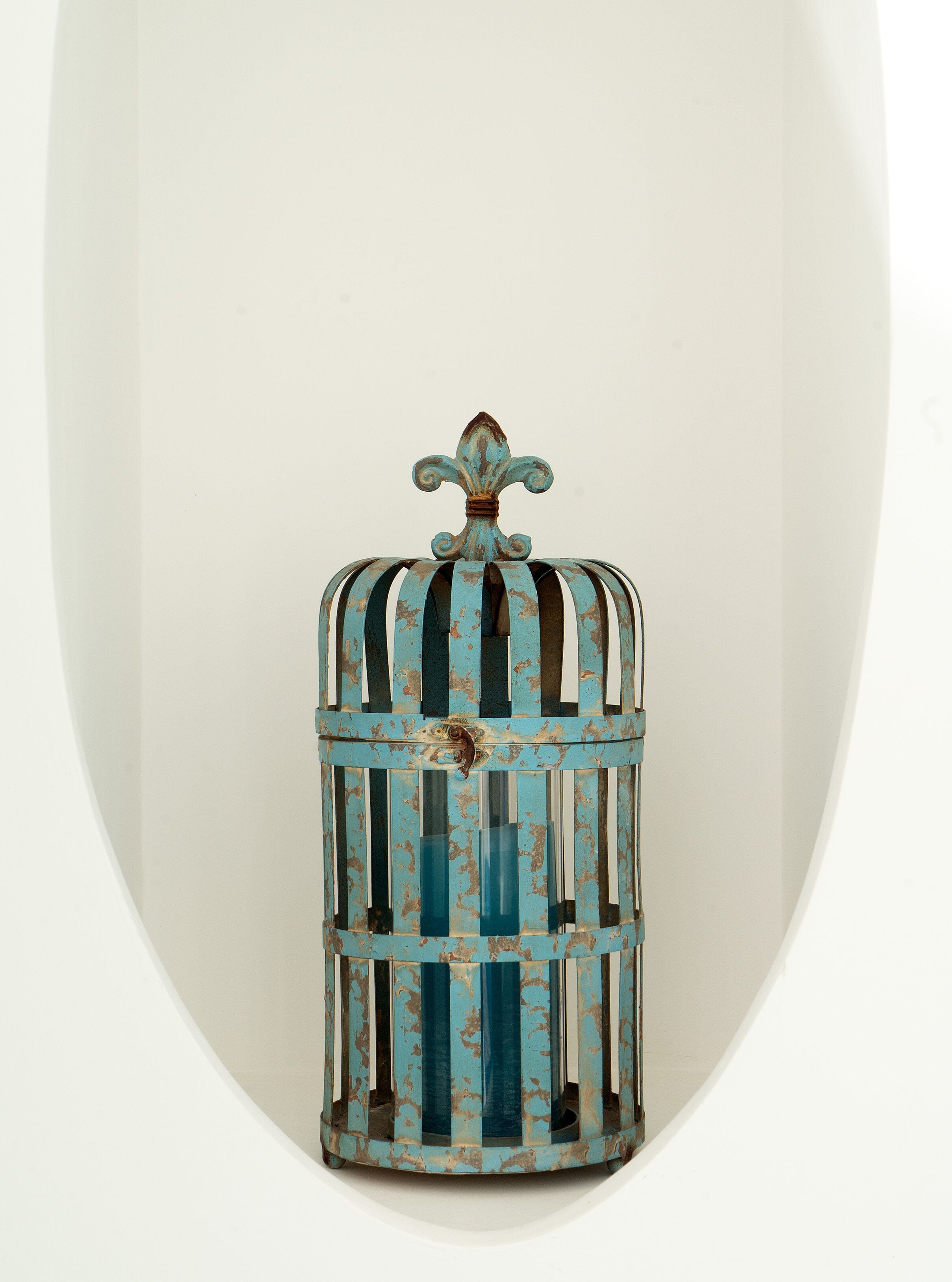 A vintage-style birdcage with a decorative top and vertical bars.