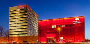 Grand Casino Basel features a distinctive architectural design with a wave-like pattern across its facade.