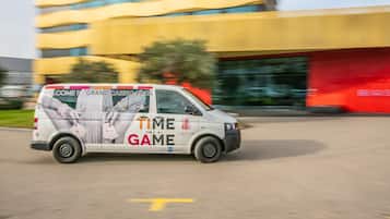 A white van with a casino advertisement parked in front of a yellow building.