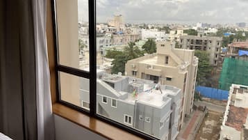 A room with a large window overlooking a cityscape.