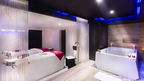 A modern spa room with a large bathtub, a massage table, and a separate shower area. - Grand Chennai by GRT Hotels (Chennai)