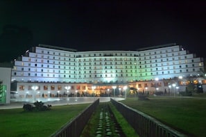 A multi-story hotel with a central courtyard, evenly spaced windows, and a symmetrical facade.