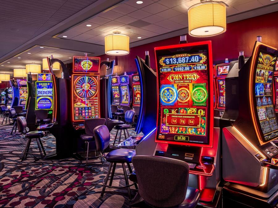 A casino floor with slot machines and chairs.